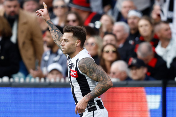 Jamie Elliott celebrates a goal during the 2024 AFL match between the Essendon Bombers and the Collingwood Magpies.