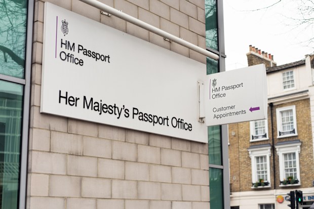 London, UK - Signs outside an HM Passport Office in the Victoria area of central London.