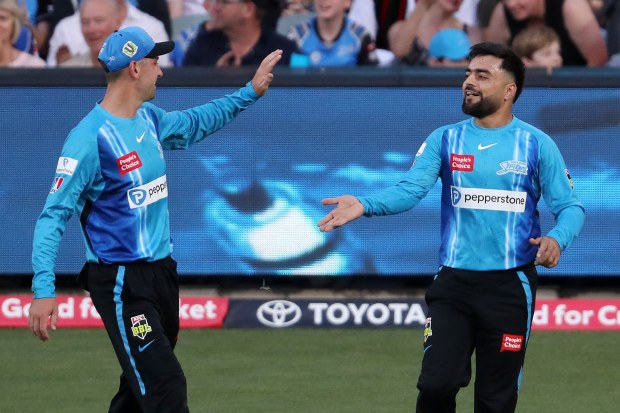 Adam Hose (left) of the Strikers congratulates Rashid Khan after he took the catch.