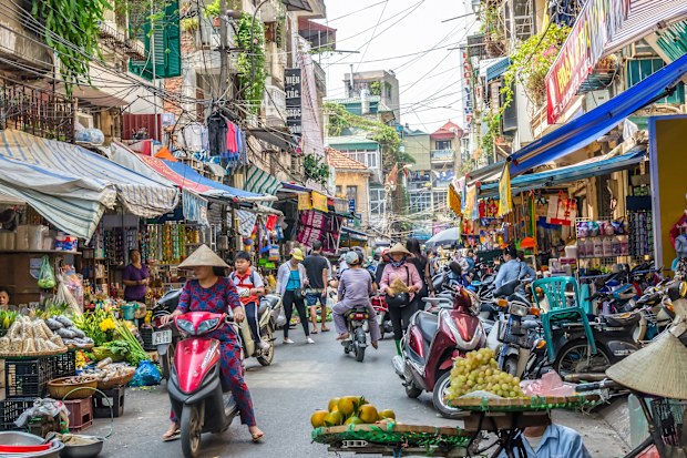 Hanoi,Vietnam - October 31,2017 : Busy local daily life of the morning street market in Hanoi, Vietnam. A busy crowd of sellers and buyers in the market.