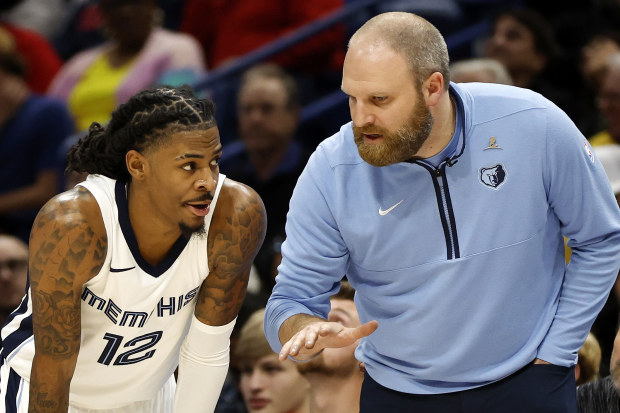 NEW ORLEANS, LOUISIANA - DECEMBER 19: Ja Morant #12 of the Memphis Grizzlies and Head Coach Taylor Jenkins of the Memphis Grizzlies speak during the game against the New Orleans Pelicans at Smoothie King Center on December 19, 2023 in New Orleans, Louisiana. 
