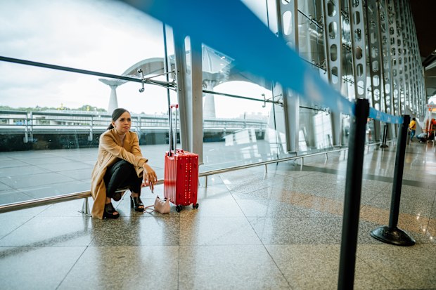 An Asian woman upset and frustrated while flight canceled at the airport