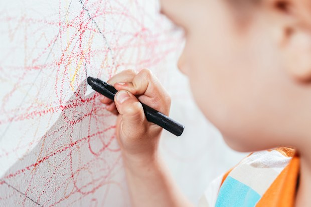 Child draws on walls with crayon