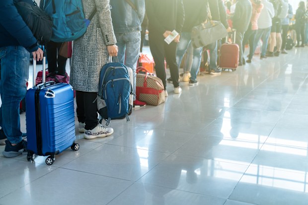 Line of people waiting at boarding gate at airport