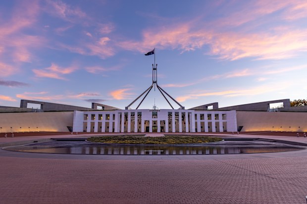 a sunset wide view of federal parliament house at canberra in the act, australia