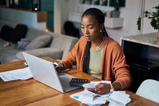 Stock Budget and home finance on laptop for accounting, money planning and fintech investment. Paper bills, savings and web payment review, online banking and insurance loan of financial taxes