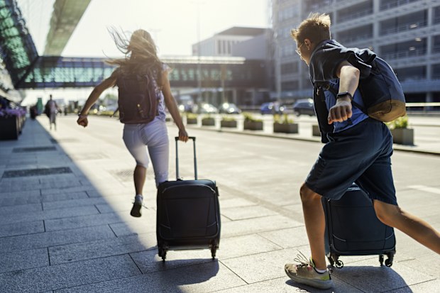 Teenage boy and girl running at the airport