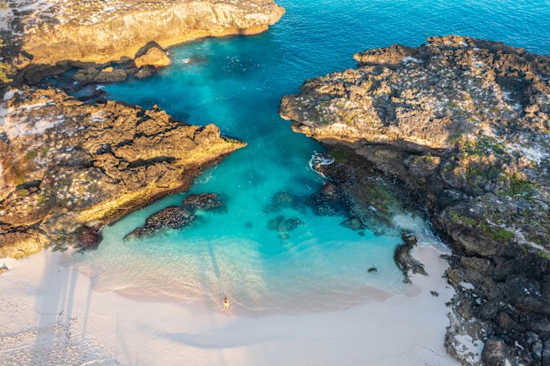 Top aerial drone view of amazing Mandorak Beach, Sumba with turquoise blue sea water. Sumba Island, Indonesia.