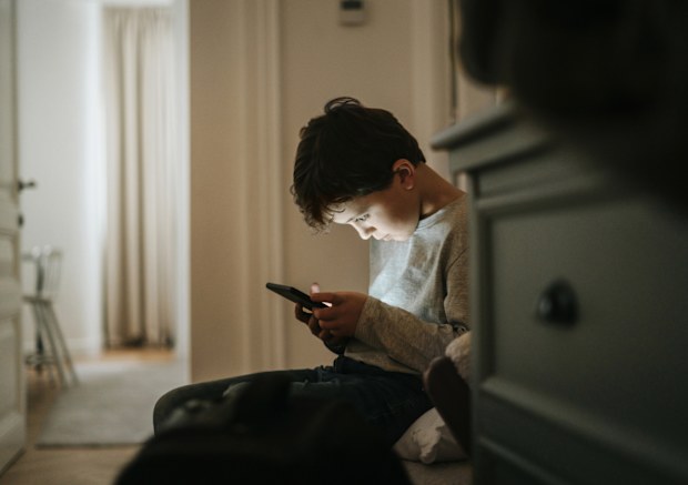 Boy playing videogames at home