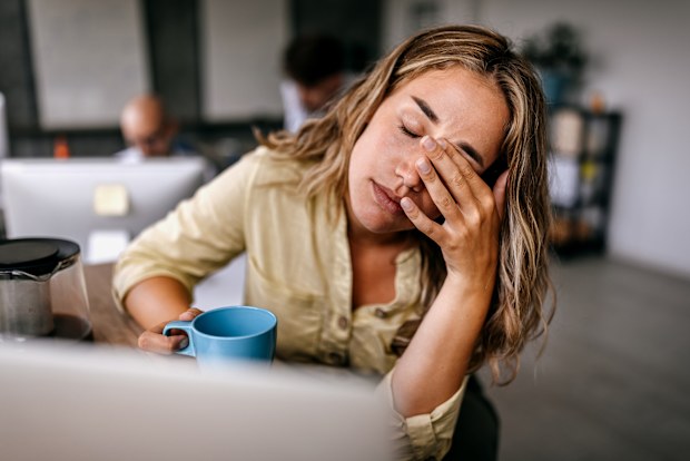 Exhausted woman at work
