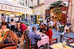 Rome, Italy, October 19 -- Dozens of customers enjoy life in a typical restaurant along an alley in the Trastevere district, in the historic heart of Rome. Trastevere is an iconic district of the Eternal City, due to the presence of countless artistic and historical treasures, monuments and ancient Romanesque and Baroque churches, but also for its squares and alleys to be explored freely, where it is easy to find typical restaurants, pubs, small shops of artisans and scenes of daily life with th