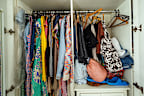 Messy closet in bedroom overstuffed with clothes