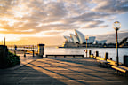 Capture the magic of Sydney's iconic Opera House bathed in the golden glow of sunrise. This breathtaking image showcases the stunning architecture and serene harbor views. Perfect for travel, nature, and architecture enthusiasts.