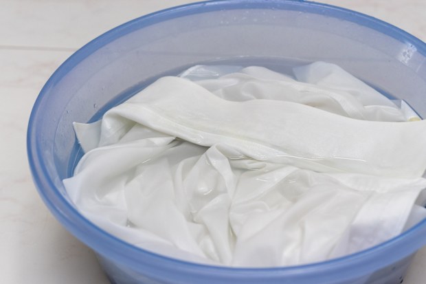 White clothes soaked in water in a basin