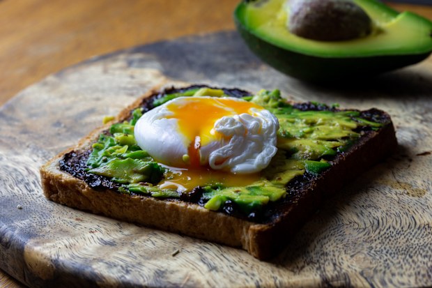 Toast with avocado and poached egg and Vegemite