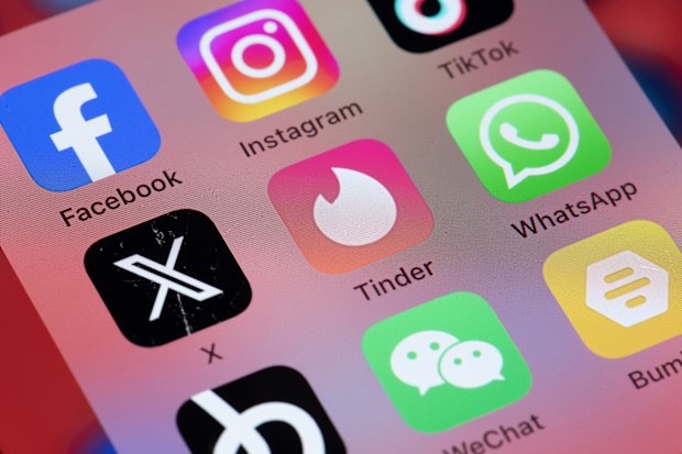 Online dating services applications Tinder, Bumble and Hppn on smart phone screen.