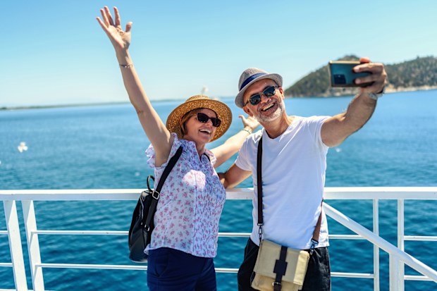 Mature couple on the ferry boat deck on a sunny day traveling on vacation