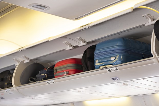 Carry-on luggage on the top shelf in airplane