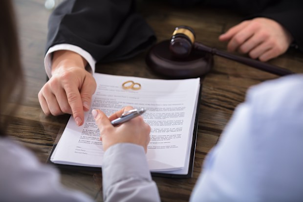 Woman signing divorce papers