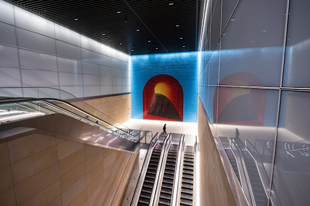 Sydney, Australia - August 22, 2024: Escalator with mosaic artwork at Gadigal station.