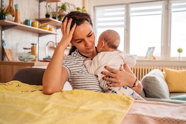 Tired and overwhelmed mum. Parental burnout is becoming more common.