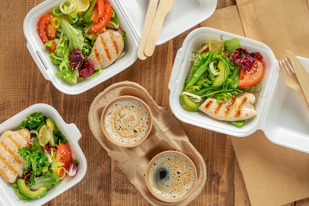 Takeaway food. Fresh salad with grilled chicken and coffee on wooden background. Top view. High quality photo