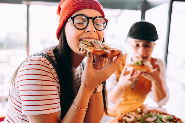 Girlfriends eat pizza