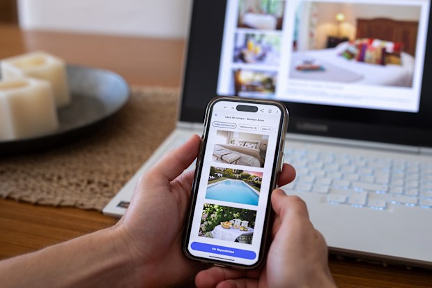 Unrecognizable person reviewing hotels online, using smartphone - Buenos Aires - Argentina