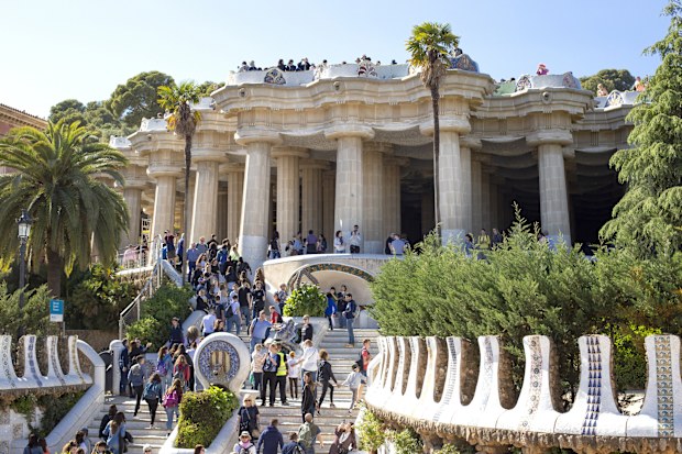 A large group of tourists in the Park Guell, one of the most famous sights in Barcelona, Catalonia, Spain 2019-05-01.