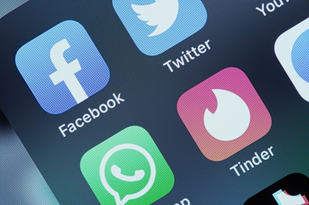 Tinder and Facebook application on screen Apple iPhone X. The composition is on a neutral background and shows the icons.