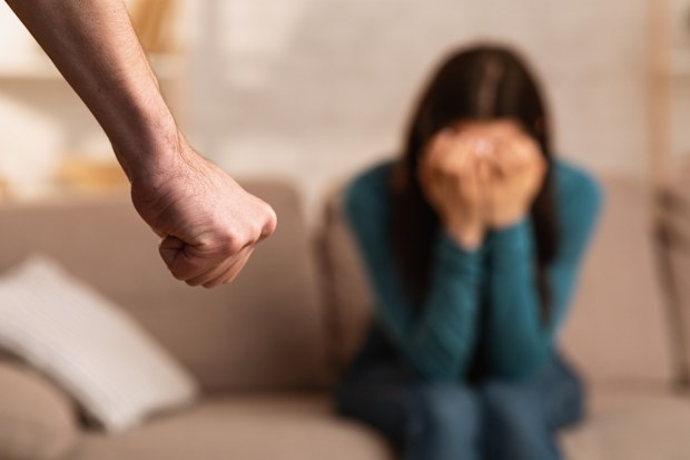 Man threatening his girlfriend with fist