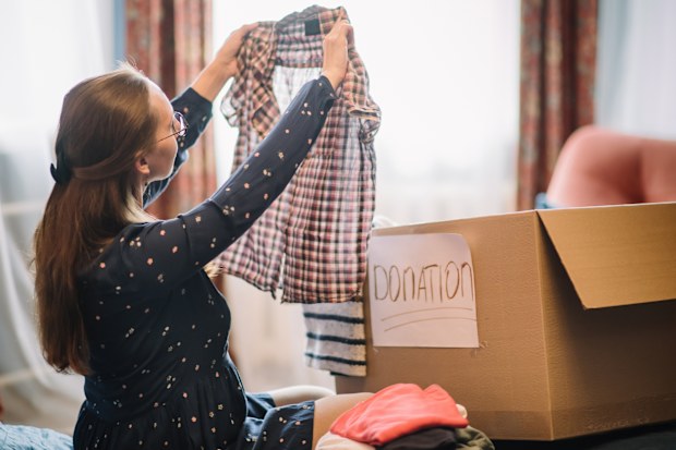 Woman preparing clothes for donation.