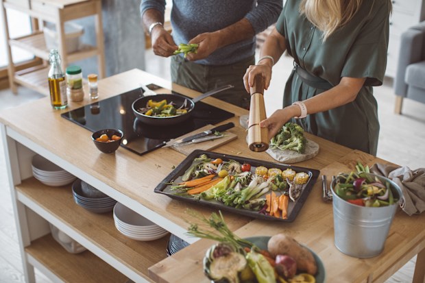 Couple preparing delicious vegetable meal, everything is so green, healthy and freshly harvested from garden