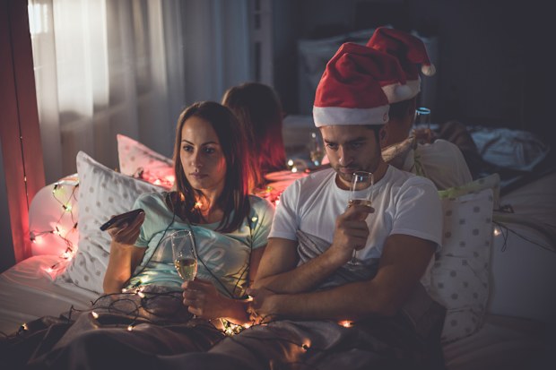 Young sad hipster couple spending time together in bed christmas