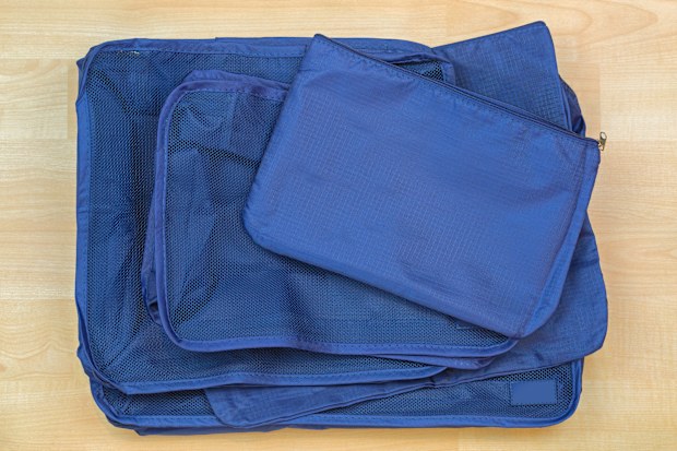 Different blue cube bags, set of travel organizer to help packing luggage easy, well organized