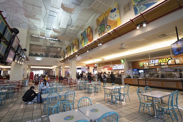 Philadelphia, USA - September 4, 2021. Travelers dining at food court inside the terminal of Philadelphia International Airport, Philadelphia, USA