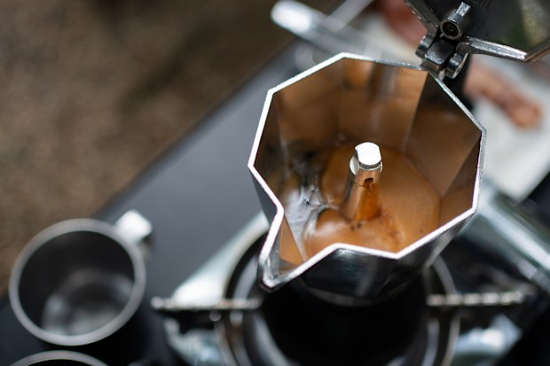 Espresso brewing in a classic moka pot on the stovetop.