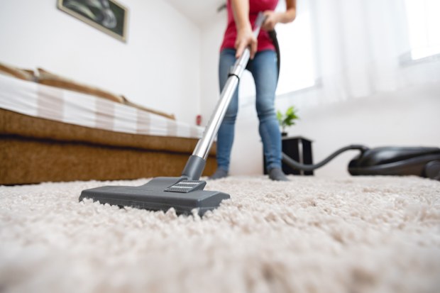 Using a vacuum cleaner to clean the carpet