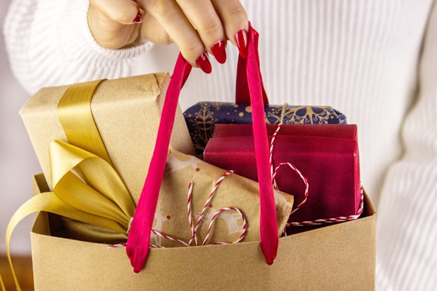 girl holding New Year's gifts in her hands. Good New Year spirit