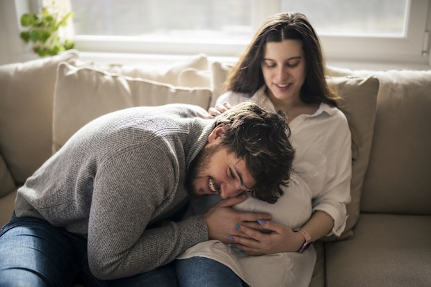 Happy couple feeling movements of baby belly of the expectant mother