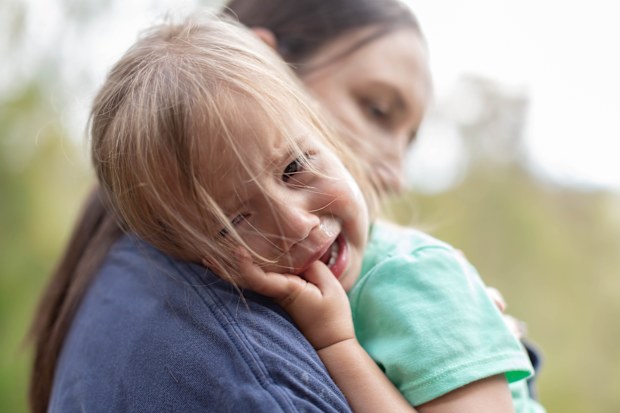 Girl is being comforted by her mother after she got hurt