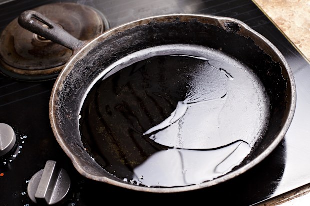 cast iron pan on stove with oil