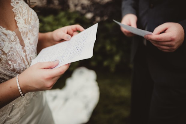 Bride and groom saying wedding vows during ceremony