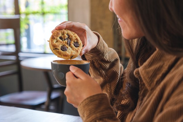 Dipping biscuit into drink