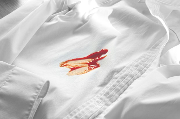 White shirt stained with tomato sauce stain on it