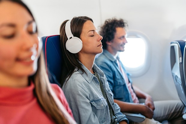 Beautiful young woman sleeping in an airplane.