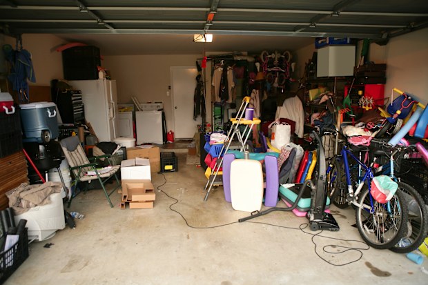 messy abandoned garage full of stuff, chaos at home stock