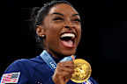 Gold medalist Simone Biles of Team United States celebrates on the podium.