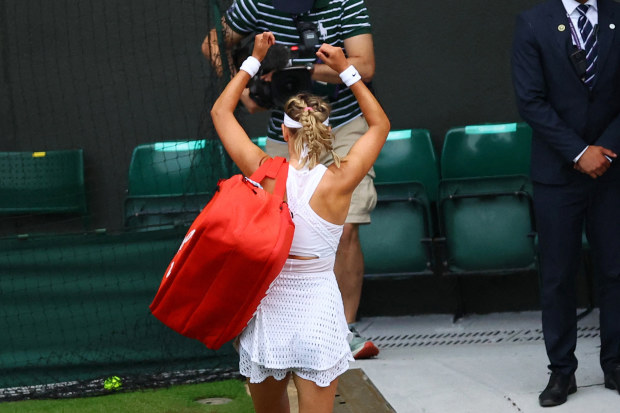 Victoria Azarenka gestures as she leaves the court after losing her fourth round match.