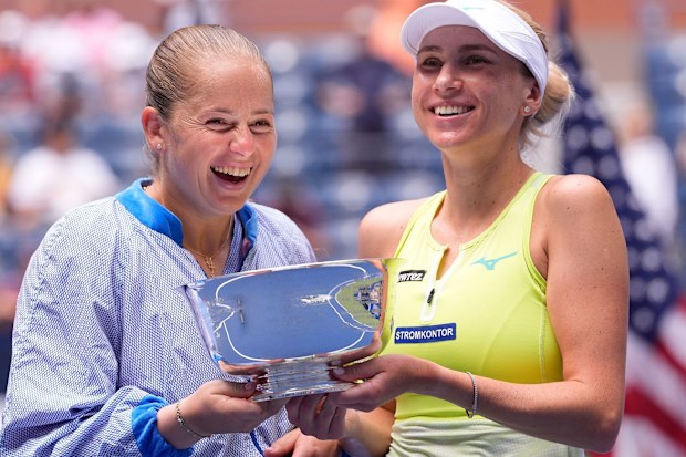 Lyudmyla Kichenok (right) and Jelena Ostapenko celebrate with the US Open trophy after winning the women's doubles final of the 2024 US Open